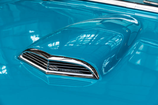 a close up of the hood of a blue car