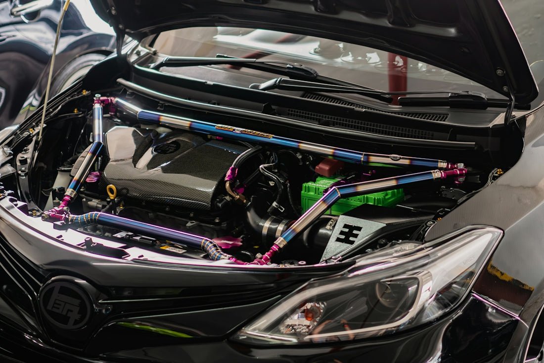 a close up of a car engine with its hood open
