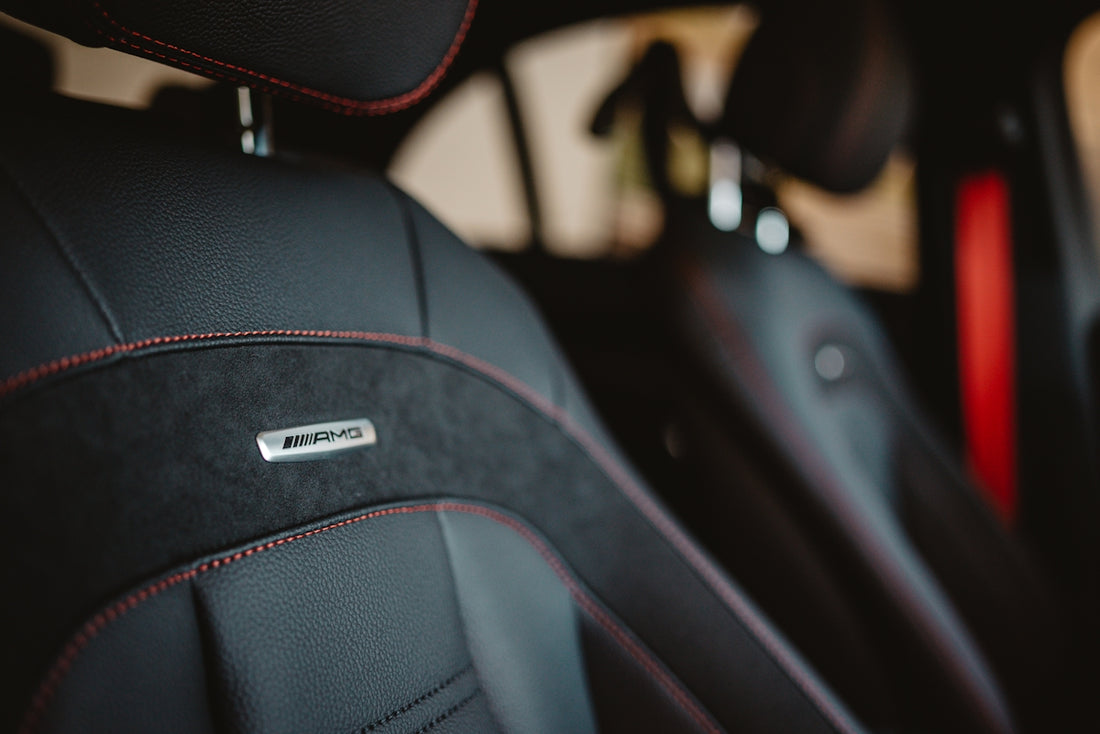 Black car seats with red stitching and amg logo
