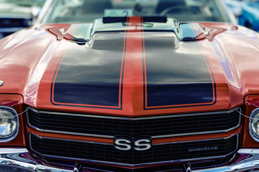 Red vintage car with black racing stripes
