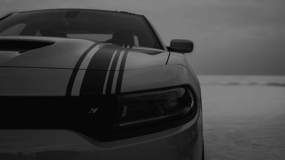 Monochrome front of a car with prominent racing stripes